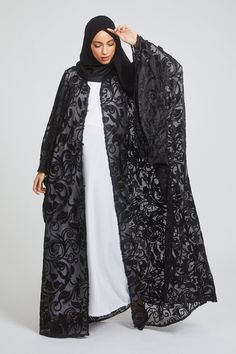 Elevate your style with this luxurious black abaya set. Adorned with delicate floral lace and hand-stitched embellishments, the farasha design is sure to make a statement. Perfect for any occasion, this set is a must-have for those who want to add a touch of elegance and glamour to their wardrobe. Fabric - Premium High Grade Polyester Hijab is included Long Sleeve Inner Slip Dress is included Stud Fasteners allows you to wear the farasha open or closed Hand stitched Embellishments all over the abaya Model is a UK dress size 8, height of 5'8, wearing a size 58 Dry Clean Only Abayas Collection, Modest Wardrobe, Black Abaya, Hijab Caps, Dresses Uk, Hand Stitched, Simple Style, Black Floral