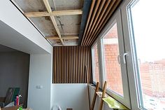 an unfinished room with wooden slats on the ceiling