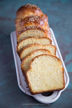 sliced loaf of bread sitting on top of a white tray