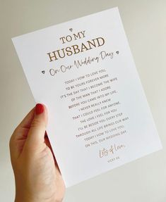 a person holding up a card that says,'to my husband on our wedding day '