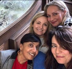 four women are posing for a photo together