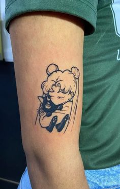 a person with a tattoo on their arm holding a teddy bear and hugging it's head