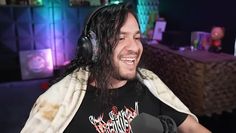 a man with long hair wearing headphones