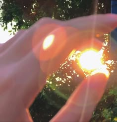 the sun is shining brightly through the palm of someone's hand