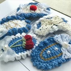 several crocheted items are laying on top of each other