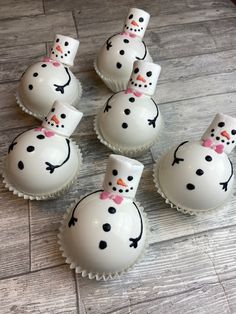 there are six snowmen on top of the cupcakes that have been made to look like them