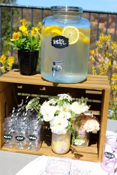 a wooden crate with flowers and lemons in it