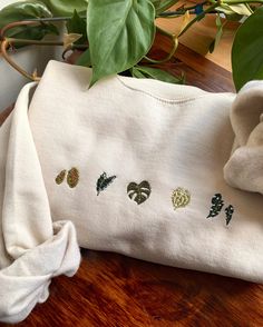 a close up of a cloth on a table near a potted plant with green leaves