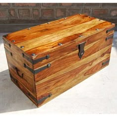 a large wooden trunk sitting on top of a cement floor