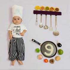 a baby doll laying on top of a table next to some cooking utensils