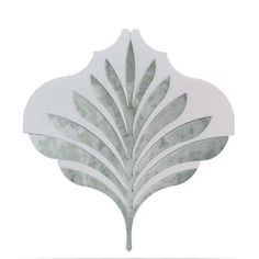 a decorative mirror with leaves on it