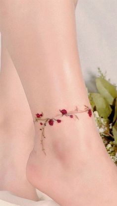 a woman's foot with a rose tattoo on the side of her left leg