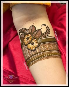 a woman's arm with a hendik on it and flowers in the middle