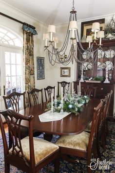 a dining room table with chairs and a chandelier