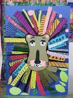 a paper cut out of a lion's head with colorful strips and leaves on it