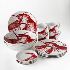 a red and white dinnerware set with lobsters on the plates, cups and saucers