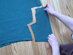 someone is cutting out the fabric for a t - shirt