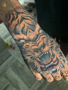 Black and white tiger hand tattoo on dark skin Ape Hand Tattoo, Tiger Hand Tattoo Men, Jaguar Hand Tattoo, White Eyes Tattoo, Black Men Hand Tattoos, Jett Tattoo, White Ink Tattoo On Dark Skin, Lion Hand Tattoo Men, White Tattoo On Dark Skin