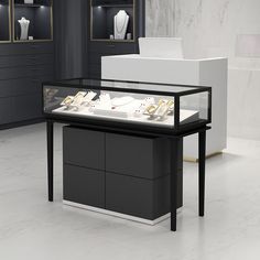 a black and white display case filled with jewelry