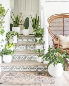 some plants are sitting on the steps in front of a door