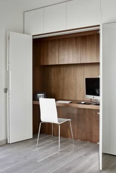 a white chair sitting in front of a wooden desk