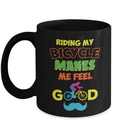 a black coffee mug with the words riding my bicycle makes me feel god