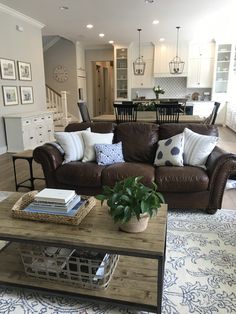 a living room filled with furniture and lots of pillows on top of it's couches