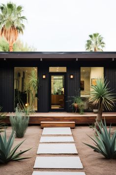 a house with plants and steps leading to the front door