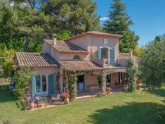 the house is surrounded by greenery and trees