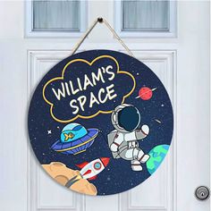 a door sign that says williams space with an astronaut and rocket ship in the background