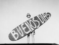 a man is holding a surfboard with the word bensdas written on it