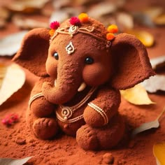 an elephant statue made out of red clay with decorations on its head and tusks