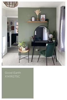 a room with green walls and furniture in the corner, there is a mirror on the wall