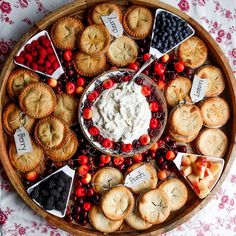 a platter filled with pies, crackers and berries