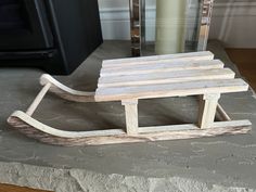 a wooden sled sitting on top of a stone counter