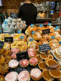 an assortment of pastries on display at a bakery