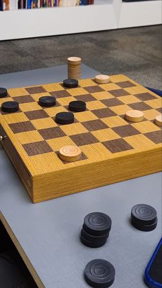 a wooden chess board sitting on top of a table