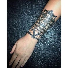 a woman's arm with a tattoo on it and an intricate design in the middle