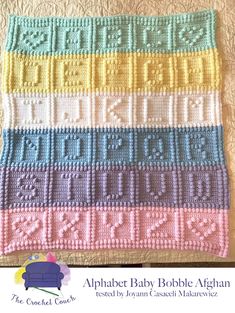 a crocheted blanket that has been made with the alphabet baby bobble afghan