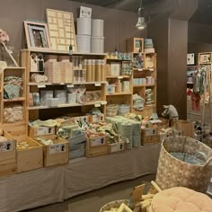 a store filled with lots of baskets and boxes full of items on shelves next to tables