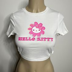 Shein Hello Kitty White And Pink Top With Tie In The Back Nwt Size Medium White Letter Print Crop Top For Spring, Cute White Stretch Tops, Stretch Hello Kitty Print Top For Summer, Cute Stretch White Crop Top, Hello Kitty Print Stretch Top For Summer, Cute White Crew Neck Crop Top, Trendy Stretch Hello Kitty Print Tops, Fitted Hello Kitty Top For Spring, Fitted Hello Kitty Tops For Spring