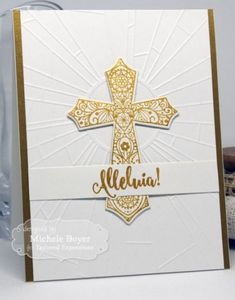 a white and gold card with a cross on it