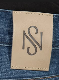 a label on the back pocket of a pair of blue jeans with white stitching