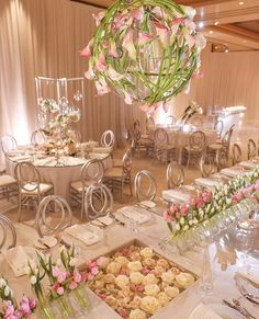 a table set up with flowers and desserts for a wedding or special event in an elegant setting