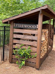 a firewood shed with logs stacked in it and a sign on the side that says,