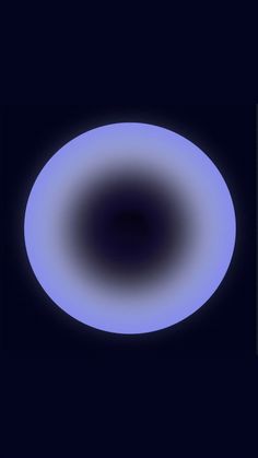 a blue and white circular object in the dark