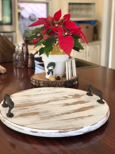 a wooden plate with a potted plant on it sitting on top of a table