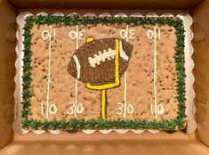 a decorated cake in the shape of a football field