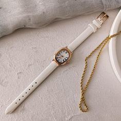 Technical specifications: ➡ Movement: Quartz ➡ Case Material: Gold colour metal ➡ Dial : White ➡ Bracelet: White Leather Strap ➡ Case Shape: Oval ➡ Case Diamensions: 18*25 mm ➡ Band Width: 10 mm ➡ Display: Analog ✈ Free Shipping Elevate your style with this exquisite women's watch, a perfect combination of gold elegance and minimalist design. Crafted for the modern woman, this dainty timepiece features a luxurious rose gold case and a smooth white leather strap, offering both comfort and sophist Small Dainty Watch, White Metal Watches With Metal Dial, White Metal Watch With Metal Dial, White Metal Watch For Gift, White Metal Watch As Gift, White Watch Accessories With Metal Dial For Gift, White Metal Dial Watch Accessories For Gift, White Watches With Leather Strap For Gifts, Gift White Watches With Leather Strap