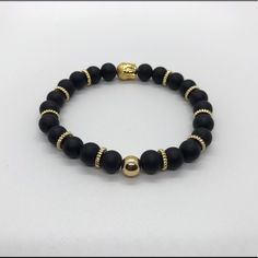 Gold Buddha And Black Beads Combination Creating A Great Piece Of Jewelry For Any Occasion Adjustable Black Beaded Bracelets With Polished Beads, Black Bracelet With Gold Beads, Black Round Beads Bracelets For Party, Black Beaded Bracelets With Gold Beads For Gifts, Black Gold Beaded Bracelet, Elegant Black Beads With Gold Details, Black Stretch Bracelet With Faceted Round Beads, Classic Black Bracelets With 8mm Beads, Black Spiritual Bracelets For Party